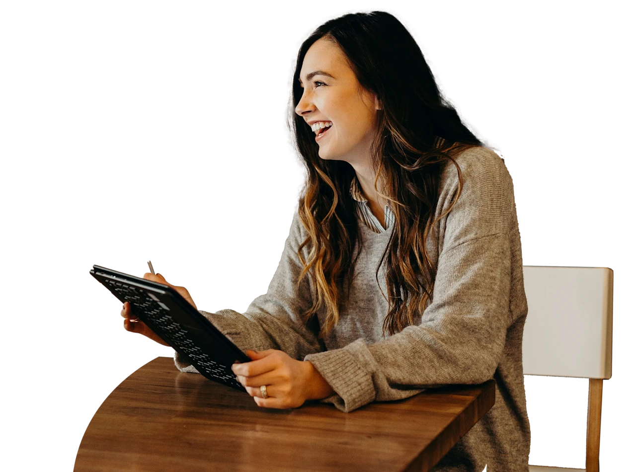 A woman holding a tablet smiling