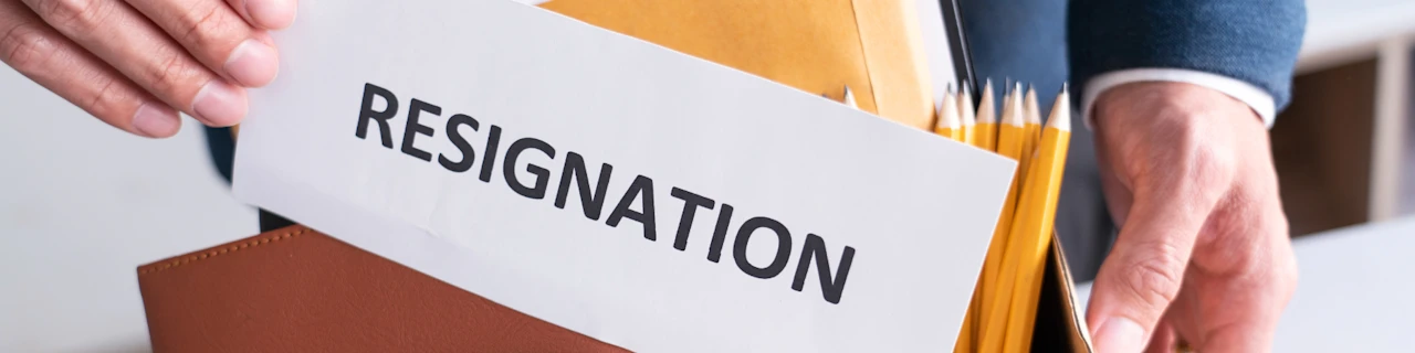 Person handing their resignation letter - banner image