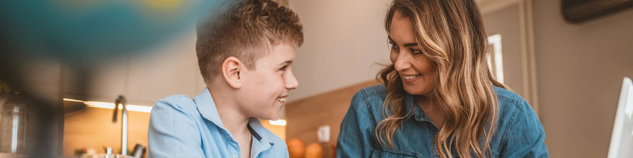 Woman teaching and boy - Demands and rewards of teaching blog - banner image